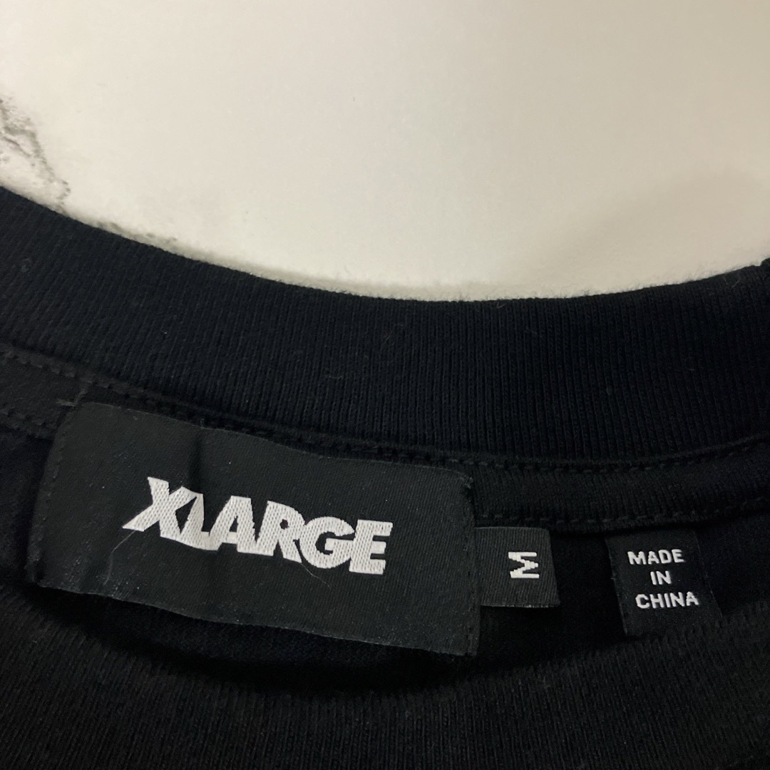 XLARGE(エクストララージ)の新品　未使用　エクストララージ　Tシャツ　黒　Mサイズ メンズのトップス(Tシャツ/カットソー(半袖/袖なし))の商品写真