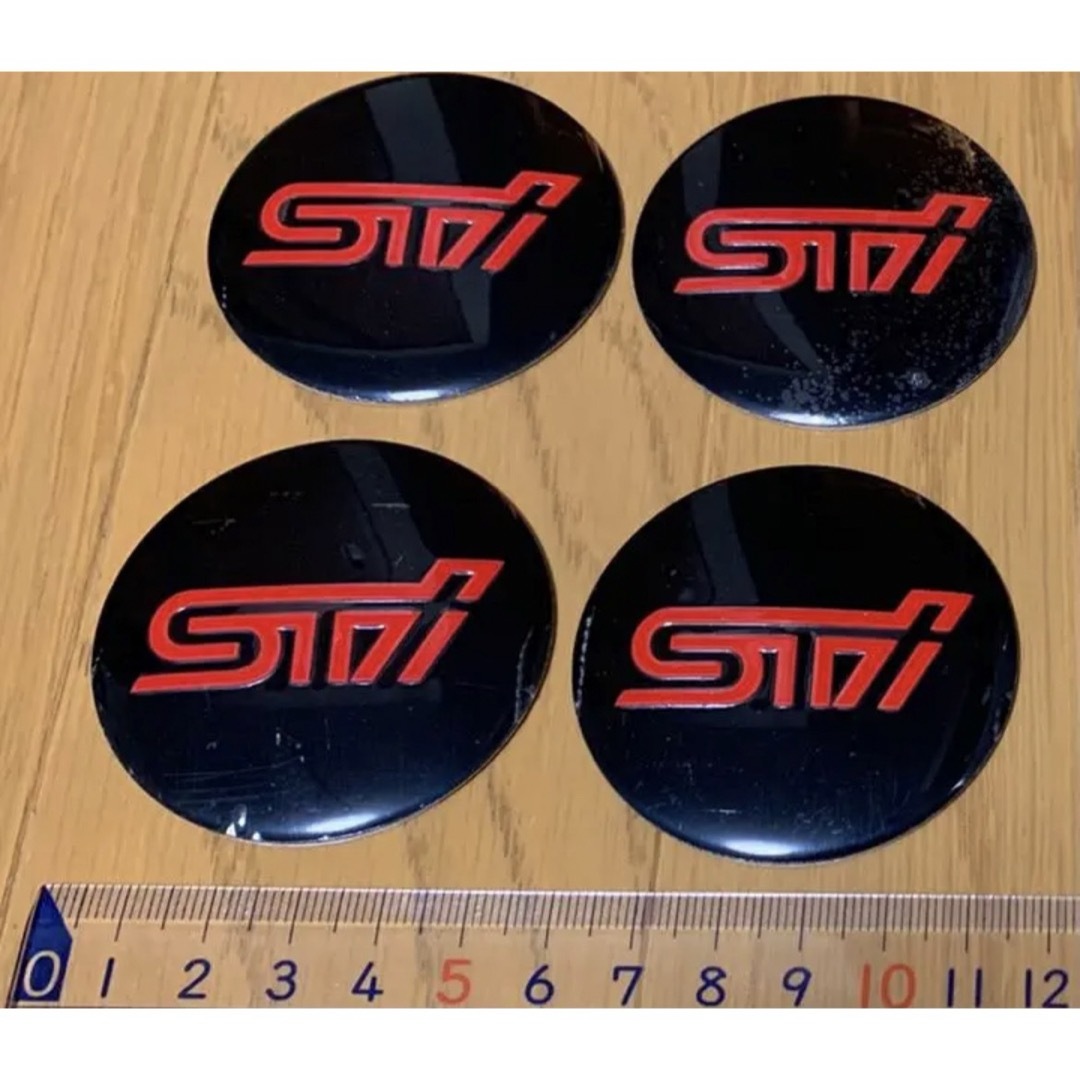 スバル(スバル)のSTI ホイールセンターキャップ 自動車/バイクの自動車(車外アクセサリ)の商品写真