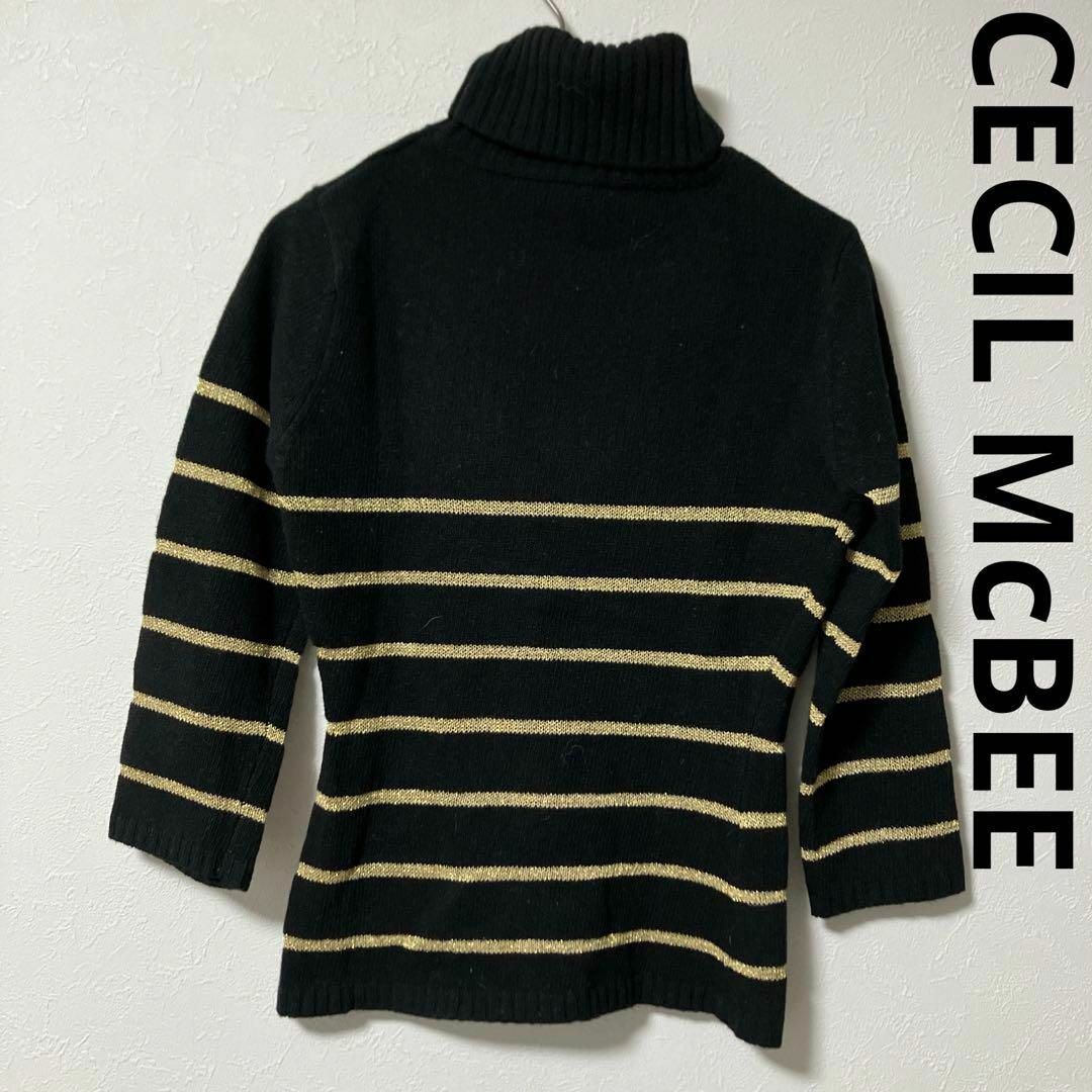 CECIL McBEE(セシルマクビー)のCECIL McBEEセシルマクビー ボーダーニット 黒×金 7部袖 レディースのトップス(ニット/セーター)の商品写真