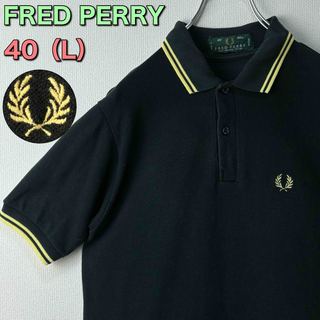 フレッドペリー(FRED PERRY)の人気　フレッドペリー　ポロシャツ　英国製　M12 　黒　黄色　40 L 古着(ポロシャツ)