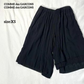 コムデギャルソンコムデギャルソン(COMME des GARCONS COMME des GARCONS)のコムデギャルソンコムデギャルソン　アシメ3連ヘム変形ラップクロップドパンツ黒XS(クロップドパンツ)