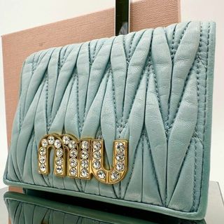 ミュウミュウ(miumiu)の【鑑定済】ミュウミュウ 二つ折り財布 ライトブルー マテラッセ ビジュー(財布)