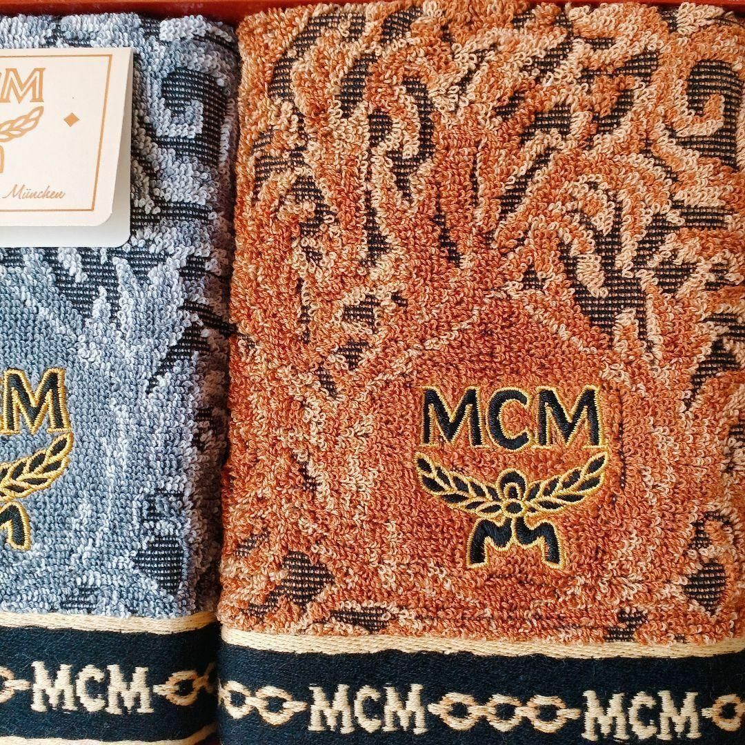 MCM(エムシーエム)の【未使用品❤️】MCM ウオッシュタオルブルーイエロー飾テープブランドロゴ刺繍 インテリア/住まい/日用品の日用品/生活雑貨/旅行(タオル/バス用品)の商品写真