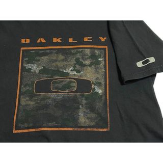 オークリー(Oakley)のOAKLEY × BUCKLE オークリー × バックル コラボ ロゴ Tシャツ(Tシャツ/カットソー(半袖/袖なし))