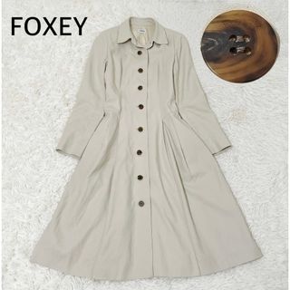 フォクシーブティック(FOXEY BOUTIQUE)のFOXEY   スプリングコート　ロングコート　トレンチコート　ロゴボタン　38(トレンチコート)