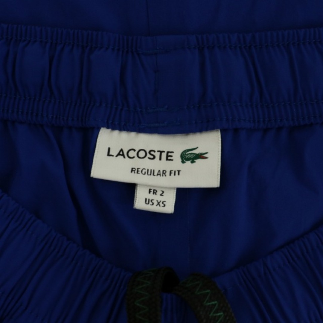 LACOSTE(ラコステ)のLACOSTE テックプリントトラックパンツ イージーパンツ XS 青 ロゴ メンズのパンツ(スラックス)の商品写真