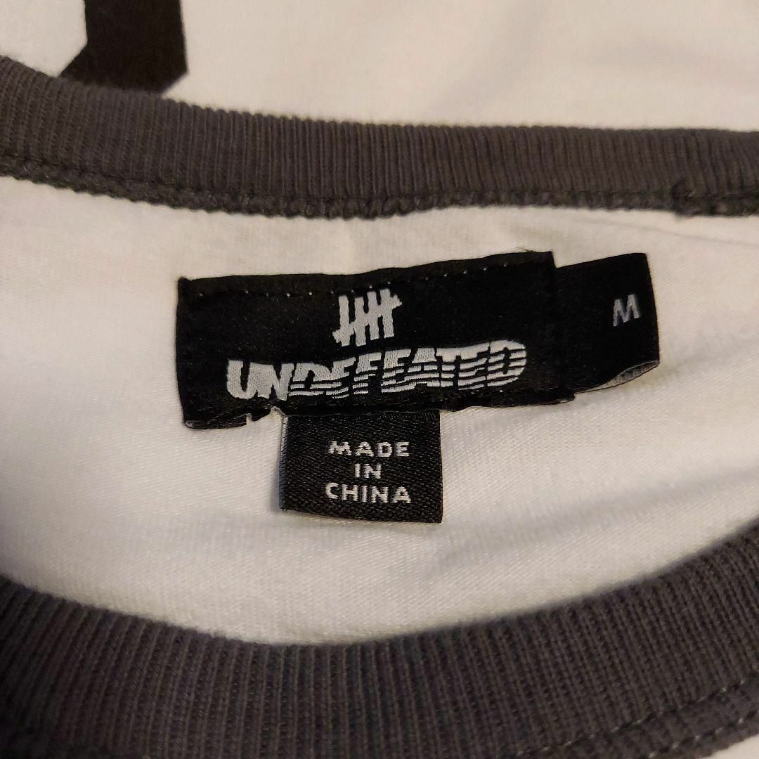 UNDEFEATED(アンディフィーテッド)のundefeated　ラグランスリーブ　シャツ　ロゴ　レトロ　古着 メンズのトップス(Tシャツ/カットソー(七分/長袖))の商品写真