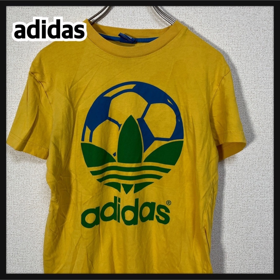 adidas(アディダス)の【アディダス】半袖Tシャツ　トレフォイルロゴ　デカロゴ　イエロー　ブラジル74 メンズのトップス(Tシャツ/カットソー(半袖/袖なし))の商品写真