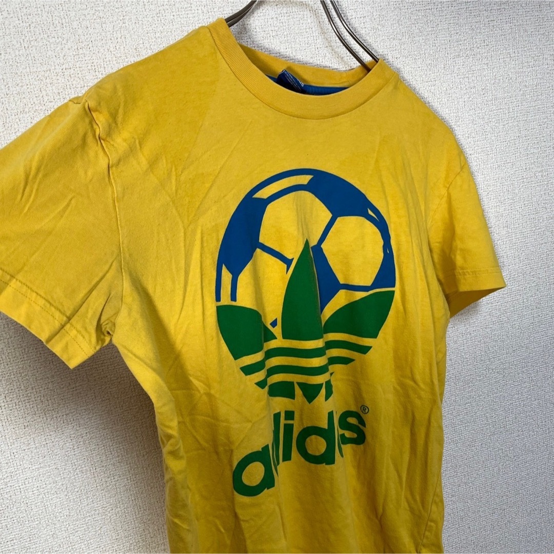 adidas(アディダス)の【アディダス】半袖Tシャツ　トレフォイルロゴ　デカロゴ　イエロー　ブラジル74 メンズのトップス(Tシャツ/カットソー(半袖/袖なし))の商品写真