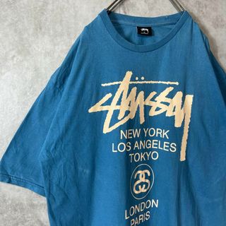 ステューシー(STUSSY)の【希少XLサイズ、メキシコ製】stussyワールドツアーロゴ古着両面プリント青(Tシャツ/カットソー(半袖/袖なし))