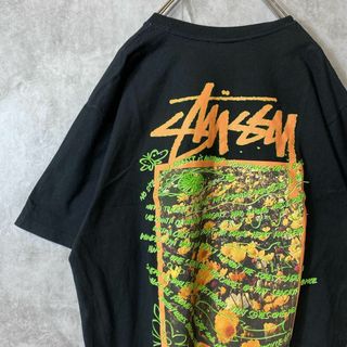 ステューシー(STUSSY)の【メキシコ製、フラワーバックプリント】stussyボタニカルTシャツ古着黒L(Tシャツ/カットソー(半袖/袖なし))