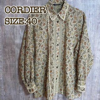 コルディア(CORDIER)のCORDIER コルディア　レトロブラウス　オーカー　総柄　フリル　レース　40(シャツ/ブラウス(長袖/七分))