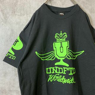 ステューシー(STUSSY)の【コラボ、両面プリント】stussy undefeated古着Tシャツ黒L(Tシャツ/カットソー(半袖/袖なし))