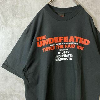 ステューシー(STUSSY)の【コラボ、両面プリント】stussy  UNDEFEATED古着Tシャツ黒(Tシャツ/カットソー(半袖/袖なし))