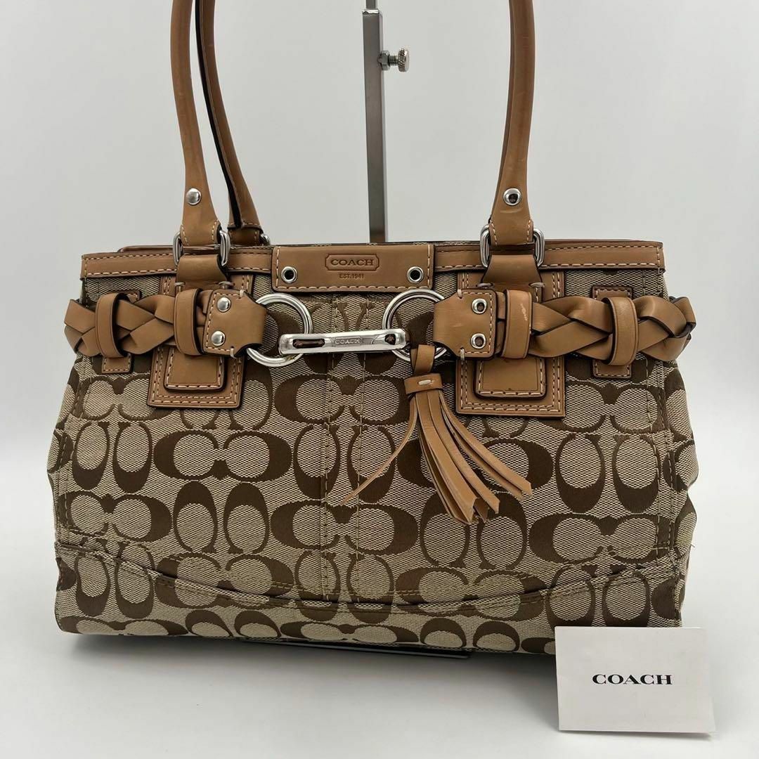 COACH(コーチ)の【極美品】coach ハンドバッグ　シグネチャー　タッセル　ベルト　金具　茶系 レディースのバッグ(ハンドバッグ)の商品写真