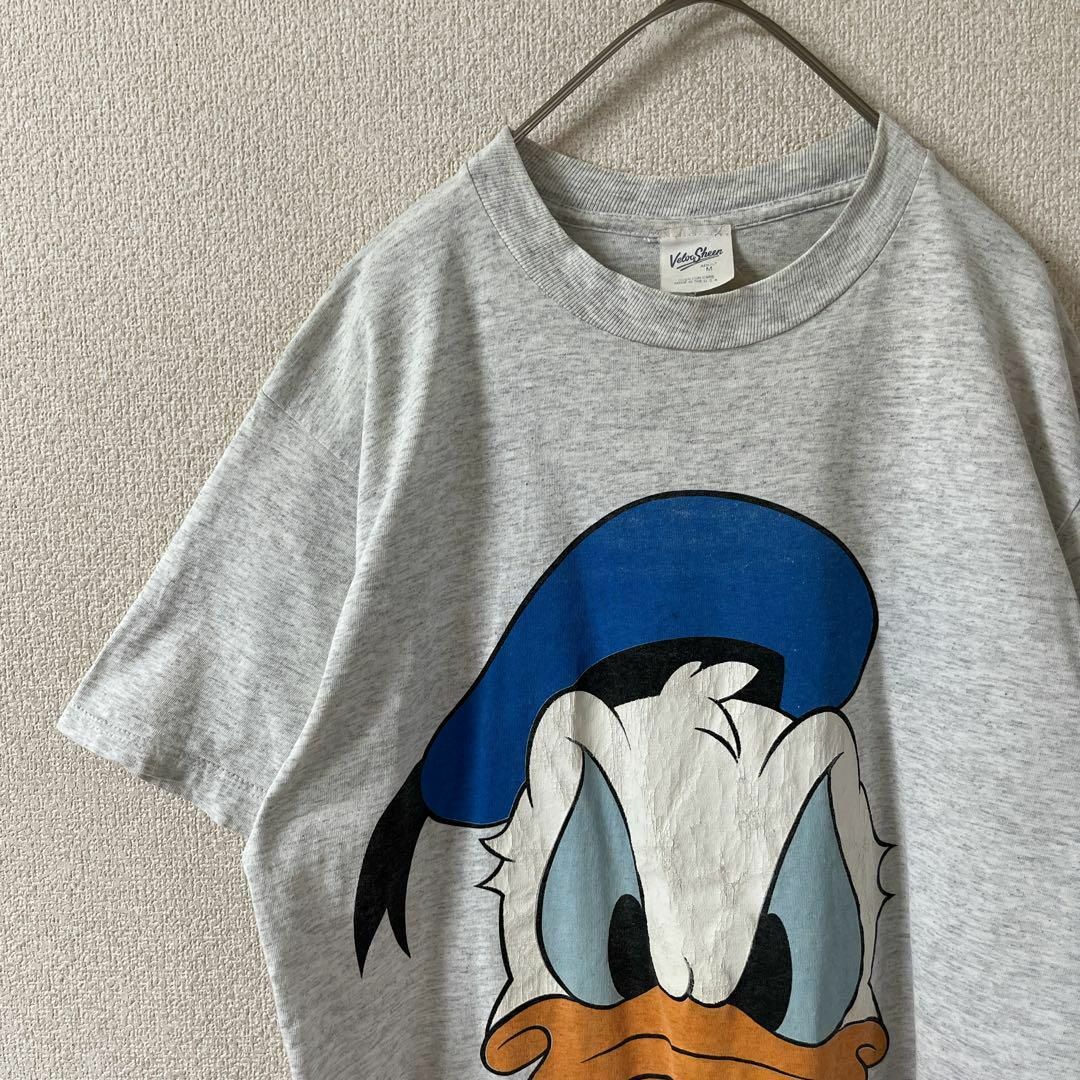 L2 Disney ドナルドダックプリントtシャツ USA製　Mメンズ 灰 メンズのトップス(Tシャツ/カットソー(半袖/袖なし))の商品写真