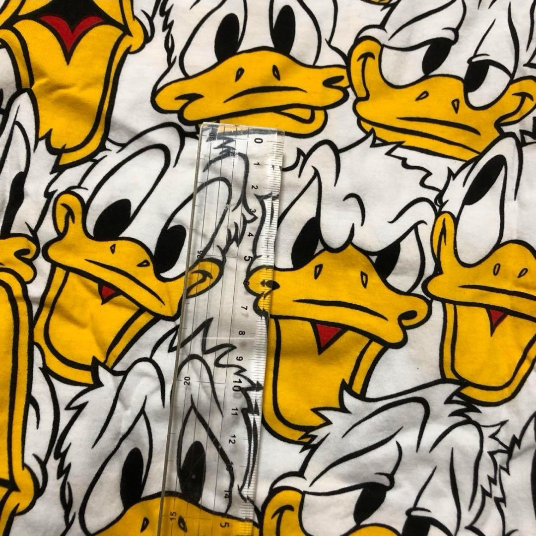 Disney(ディズニー)の【Tシャツ】BIG  ドナルド　フェイス　総柄 レディースのトップス(Tシャツ(半袖/袖なし))の商品写真