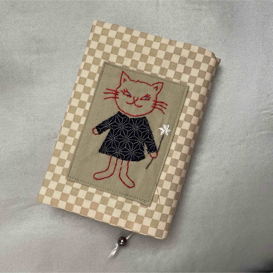 ハンドメイドのブックカバー、文庫本サイズ　刺繍　ネコちゃん ハンドメイドの文具/ステーショナリー(ブックカバー)の商品写真