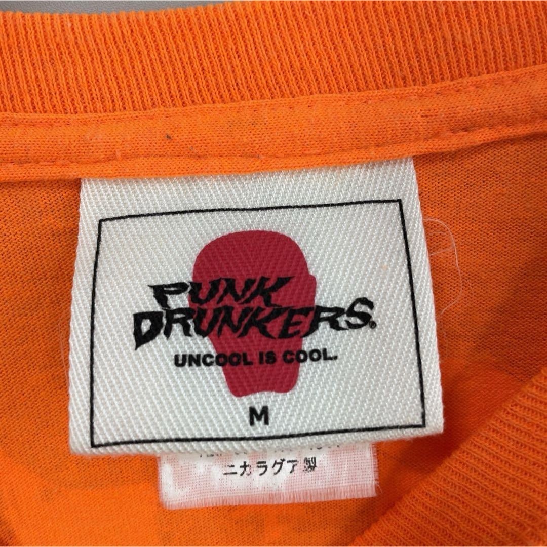 PUNK DRUNKERS(パンクドランカーズ)の【希少コラボ】パンクドランカーズ　✖︎ クッキー　長袖Tシャツ古着オレンジ袖ろご メンズのトップス(Tシャツ/カットソー(七分/長袖))の商品写真