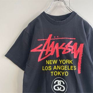 ステューシー(STUSSY)の【両面プリント、ワールドツアーロゴ】stussyマルチカラー古着ストリートM(Tシャツ/カットソー(半袖/袖なし))