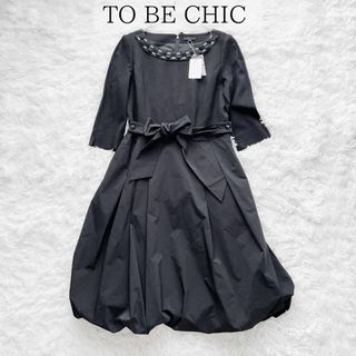 トゥービーシック(TO BE CHIC)の【未使用品】トゥービーシック ビジュー バルーンスカート ワンピース 黒 40(ひざ丈ワンピース)