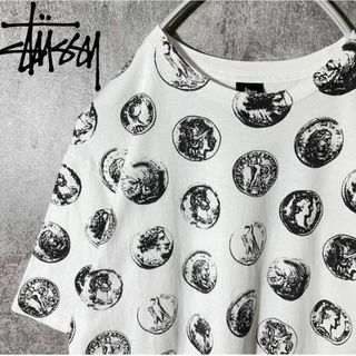 ステューシー(STUSSY)の[大人気] ステューシー　Tシャツ　硬貨　外国銀貨　総柄　メダル　コイン　レア◎(Tシャツ/カットソー(七分/長袖))