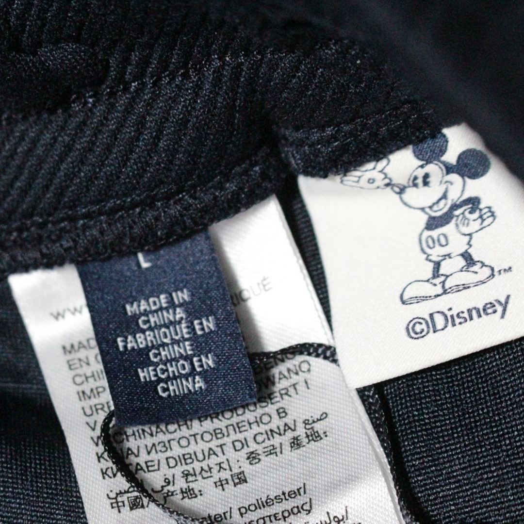 TOMMY HILFIGER(トミーヒルフィガー)の新品 ディズニートミー ミッキーモノグラム柄 ジャージーパンツ L（W86） メンズのパンツ(その他)の商品写真