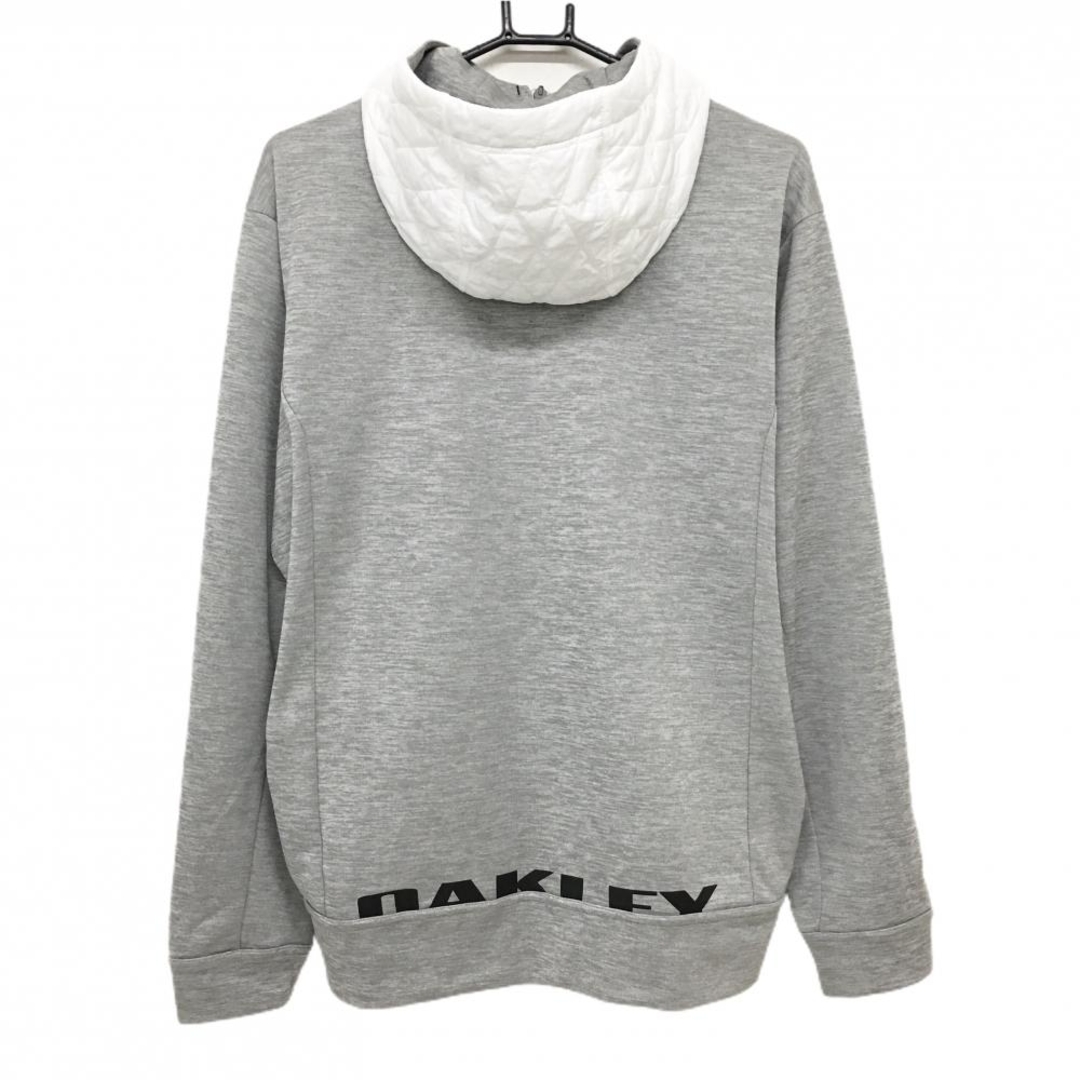 Oakley(オークリー)の【超美品】オークリー フード付き切替中綿ジャケット 白×杢グレー フード・前身頃中綿 肩ロゴ メンズ XL ゴルフウェア Oakley スポーツ/アウトドアのゴルフ(ウエア)の商品写真