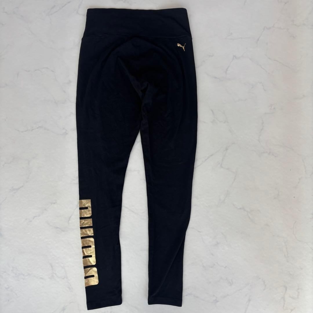 PUMA(プーマ)のPUMA レギンス ゴールドロゴ L（C120） レディースのレッグウェア(レギンス/スパッツ)の商品写真